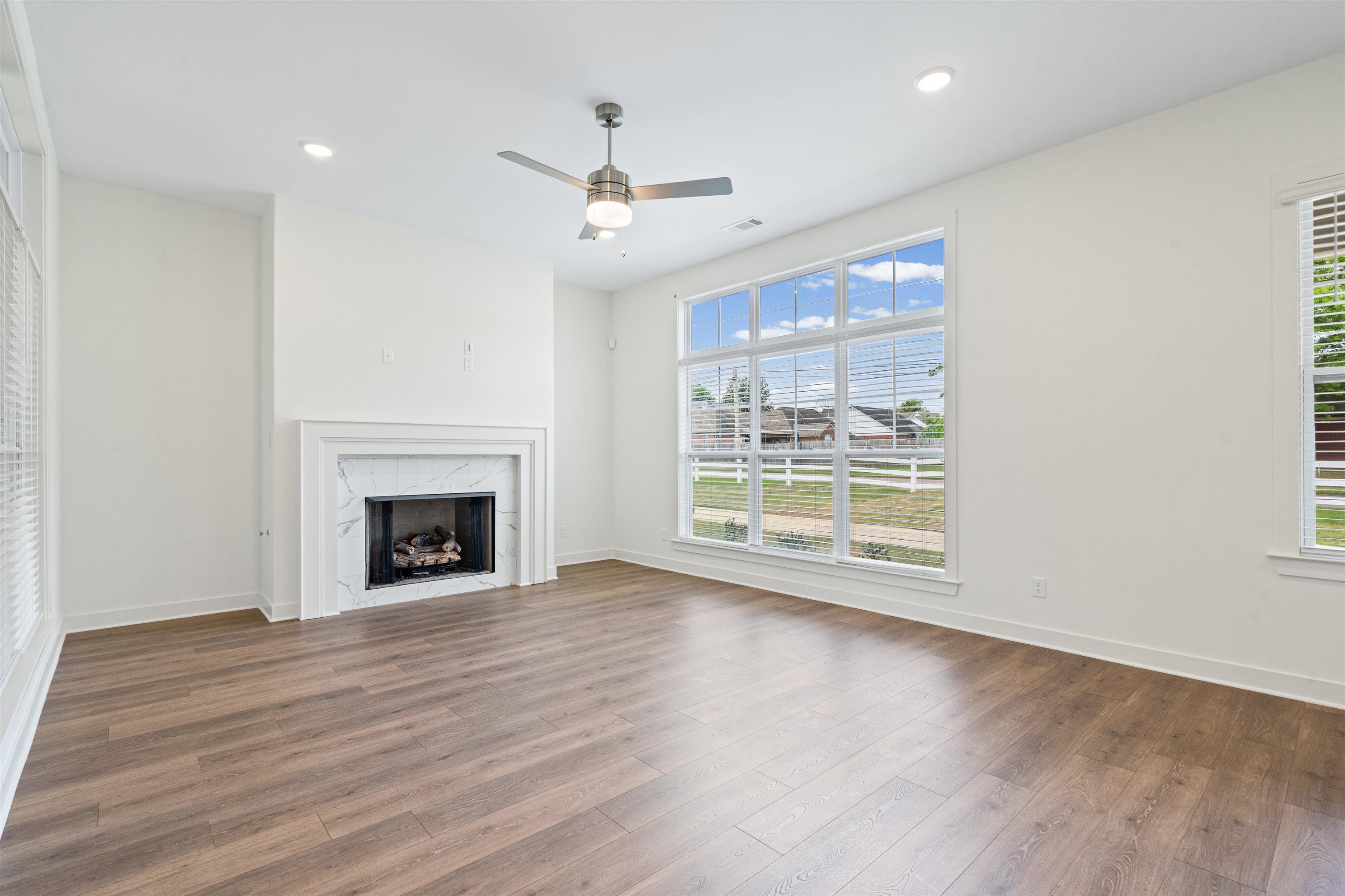5698 Gerber Road Arlington, TN 38002 - Photo 6 of 29 Unfurnished living room featuring ceiling fan, recessed lighting, a high end fireplace, and dark wood-type flooring
