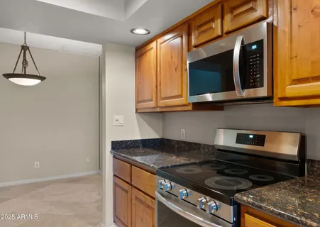 a view of a kitchen with refrigerator and cabinets