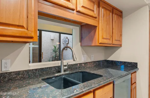 a kitchen with stainless steel appliances granite countertop a stove and a sink