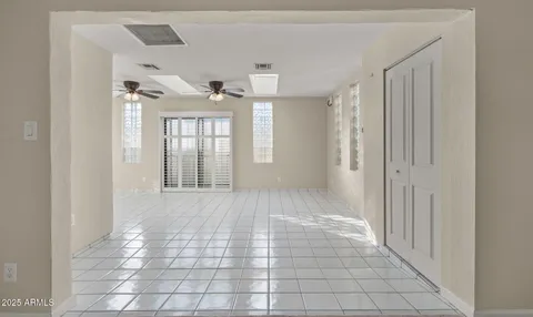 a view of empty room with fireplace and fan