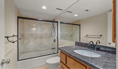 a view of an empty room with a ceiling fan and window