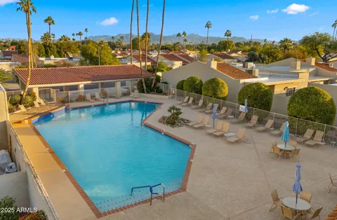 a view of a swimming pool with outdoor seating