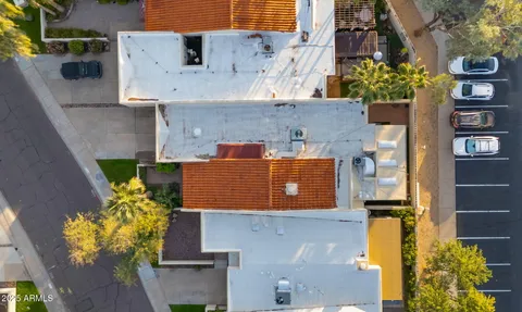 a aerial view of a house with a yard and large tree