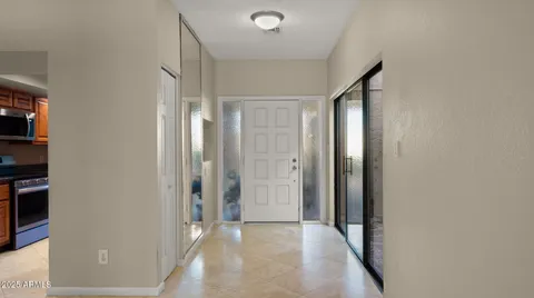 a view of a hallway with chairs and potted plants
