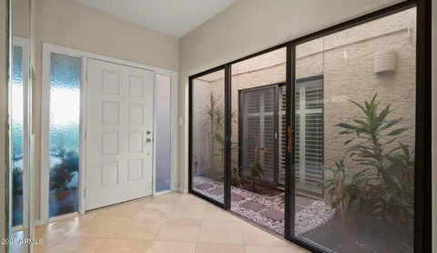 a view of a hallway with wooden shelves