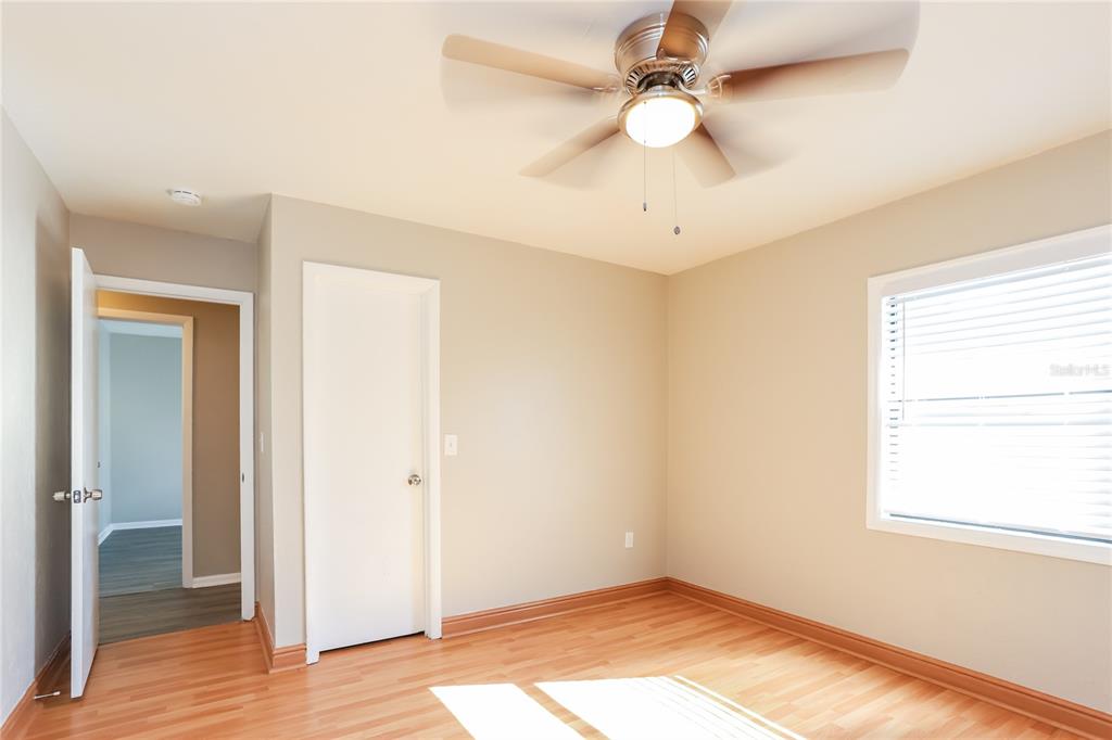 609 Willow Run Lakeland, FL 33813 - Photo 12 of 16 wooden floor in an empty room with a window