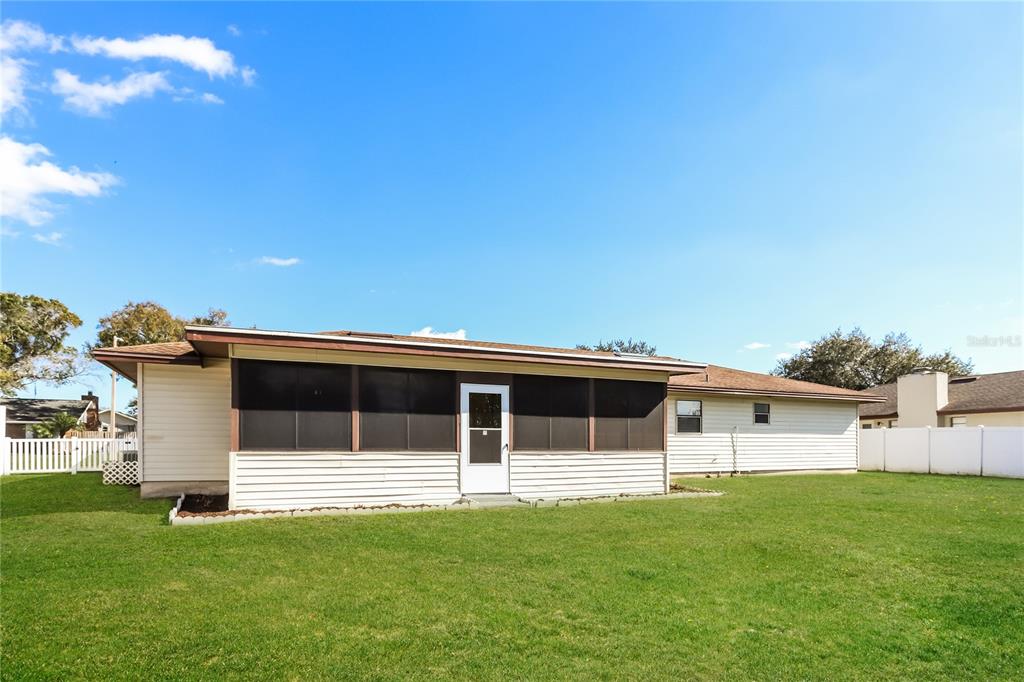 609 Willow Run Lakeland, FL 33813 - Photo 15 of 16 a front view of a house with a garden