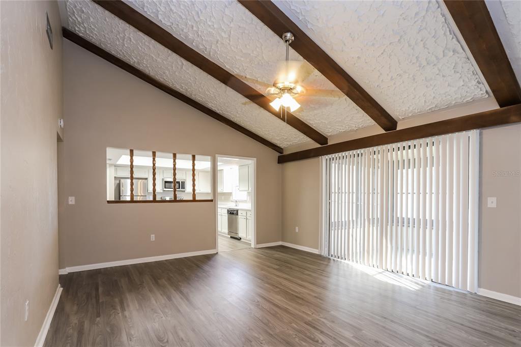 609 Willow Run Lakeland, FL 33813 - Photo 2 of 16 an empty room with wooden floor and windows