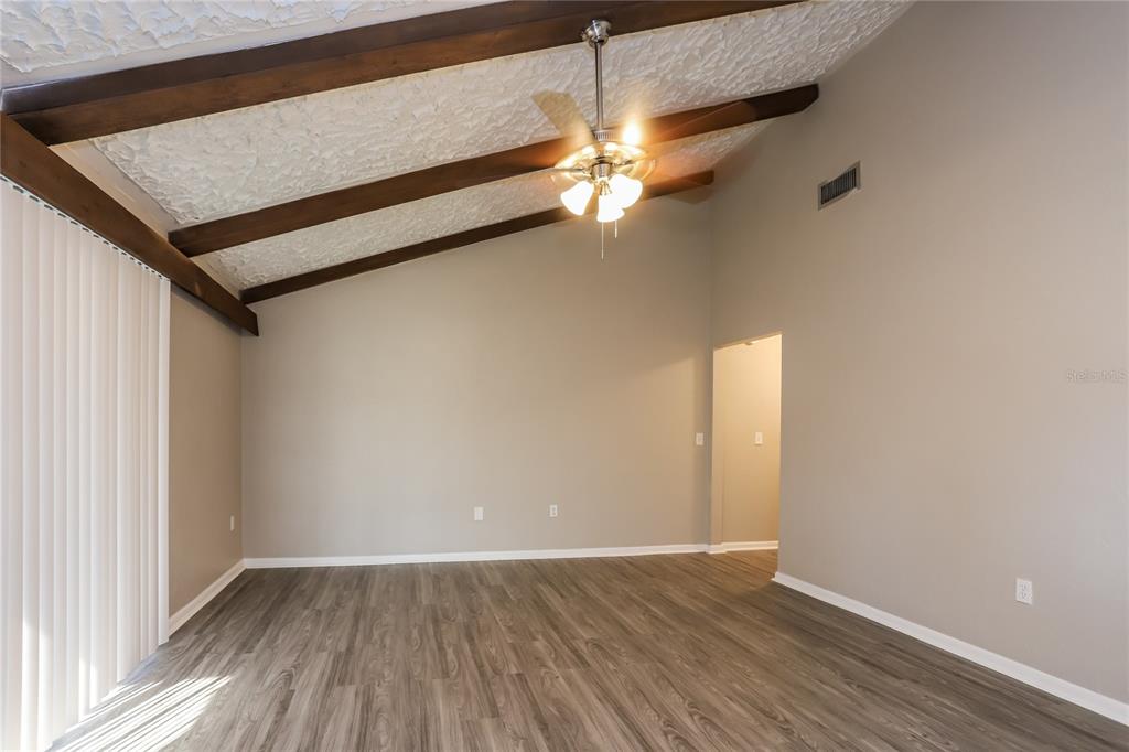 609 Willow Run Lakeland, FL 33813 - Photo 3 of 16 a view of a room with wooden floor and fan