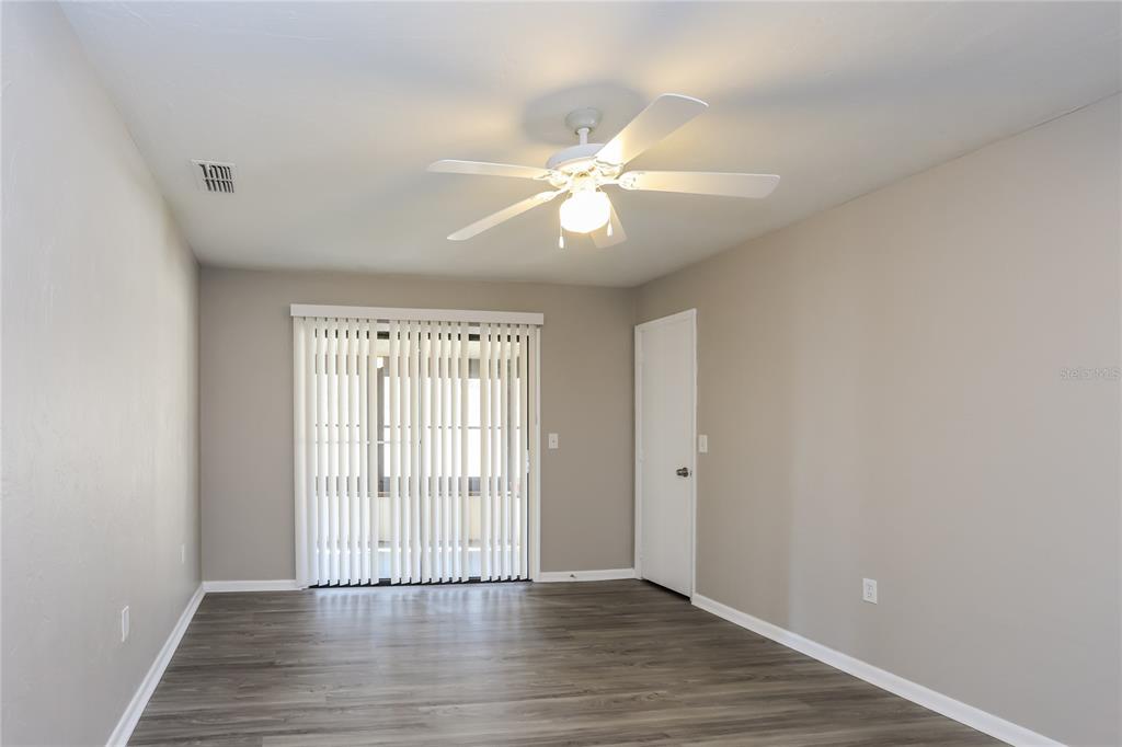 609 Willow Run Lakeland, FL 33813 - Photo 8 of 16 wooden floor in an empty room with a window