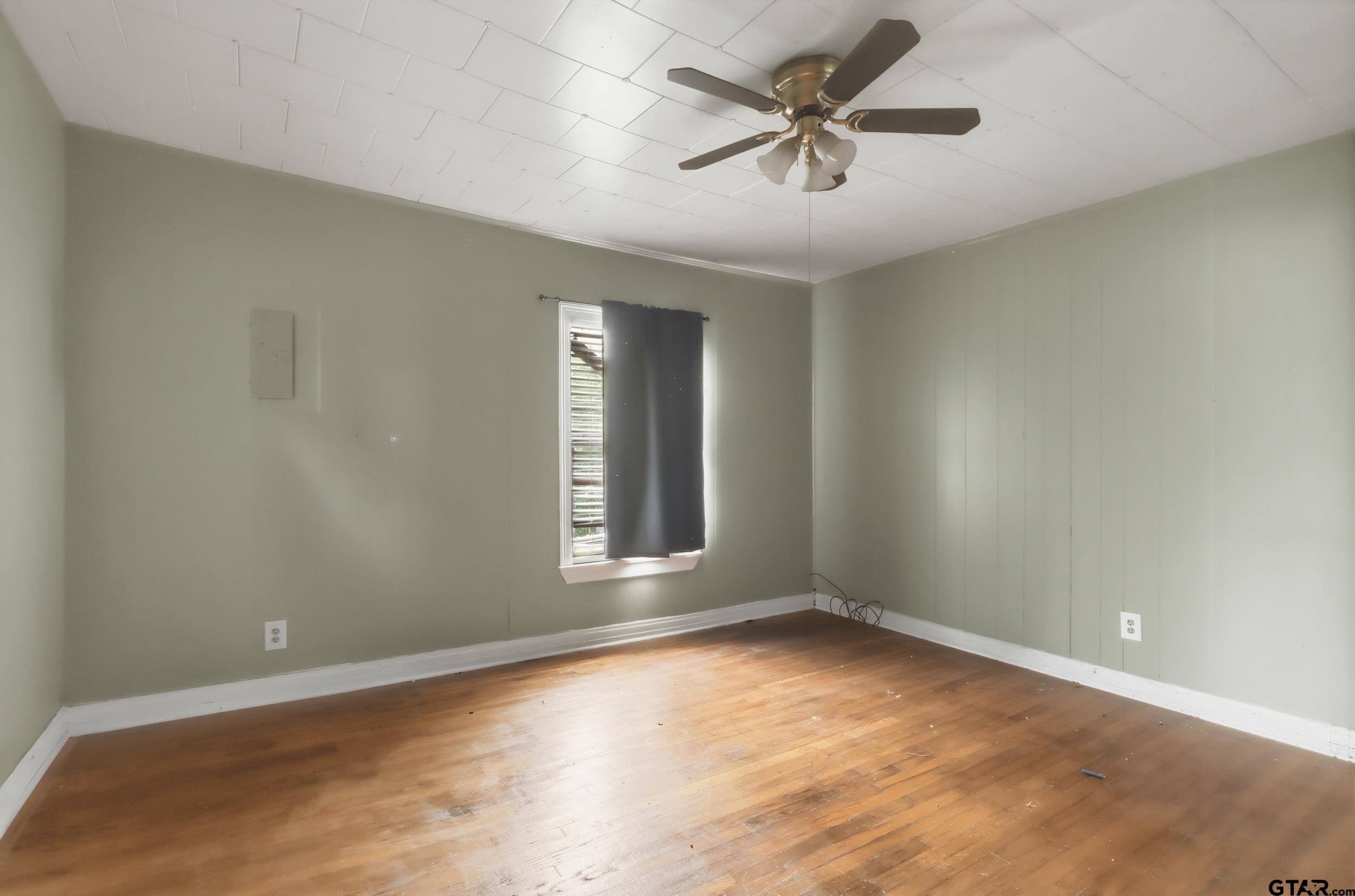 405 Rusk Street Pittsburg, TX 75686 - Photo 13 of 33 an empty room with a empty space and a ceiling fan
