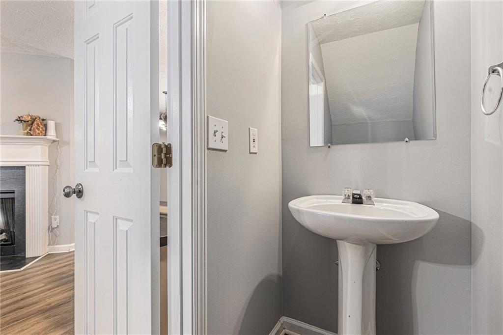 6536 Arbor Gate Drive Southwest, Unit 2 Mableton, GA 30126 - Photo 13 of 27 a bathroom with a sink a mirror and shower