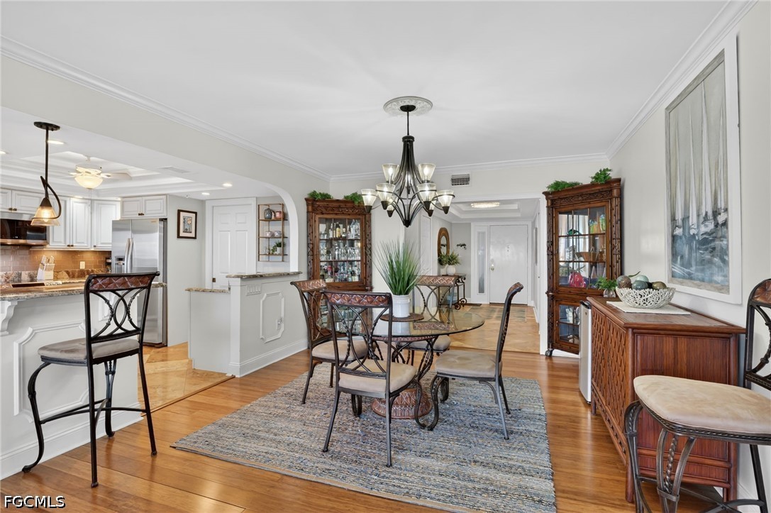 1900 Virginia Avenue, Unit 802 Fort Myers, FL 33901 - Photo 11 of 33 a view of a dining room with furniture and wooden floor