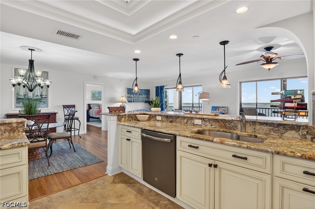 1900 Virginia Avenue, Unit 802 Fort Myers, FL 33901 - Photo 14 of 33 a kitchen with kitchen island granite countertop a stove a sink a dining table and chairs with wooden floor