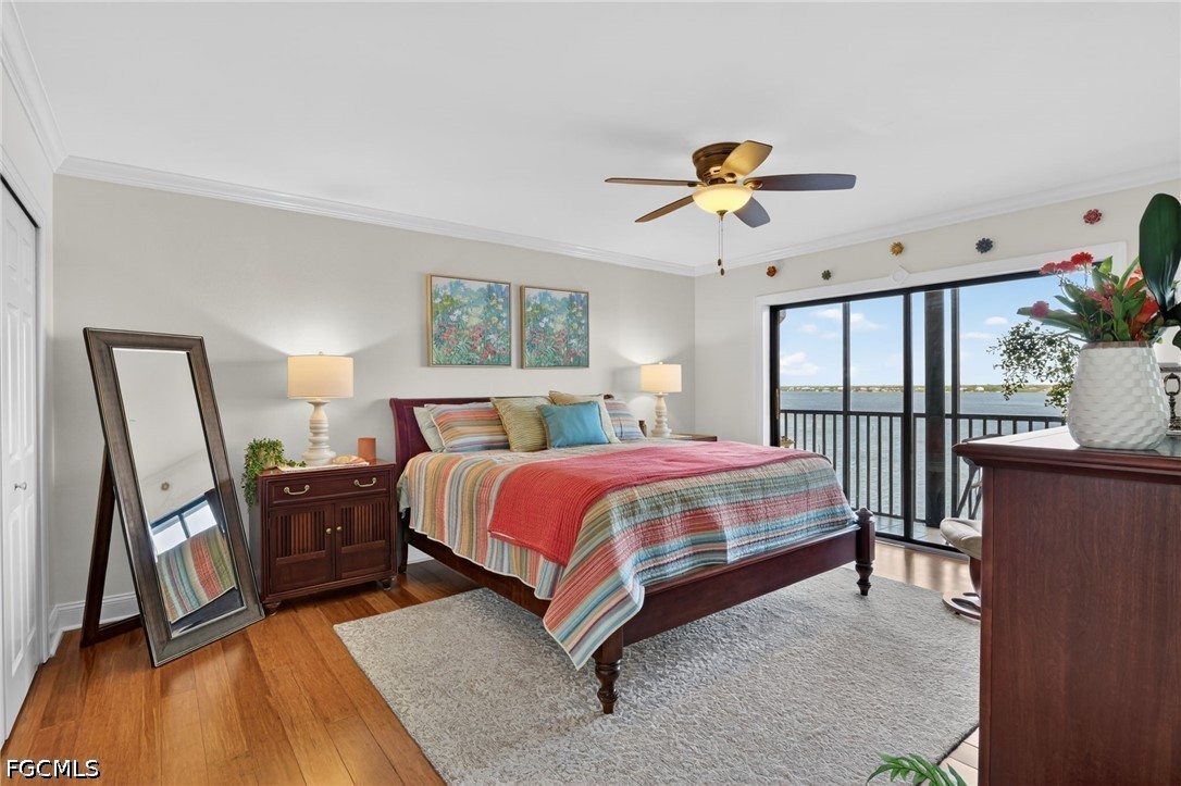 1900 Virginia Avenue, Unit 802 Fort Myers, FL 33901 - Photo 16 of 33 a spacious bedroom with a bed and a chandelier