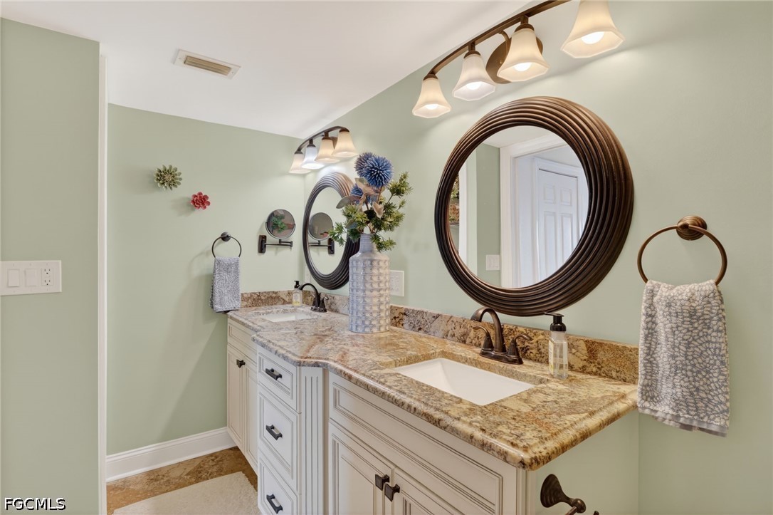 1900 Virginia Avenue, Unit 802 Fort Myers, FL 33901 - Photo 20 of 33 a bathroom with a granite countertop sink and a mirror