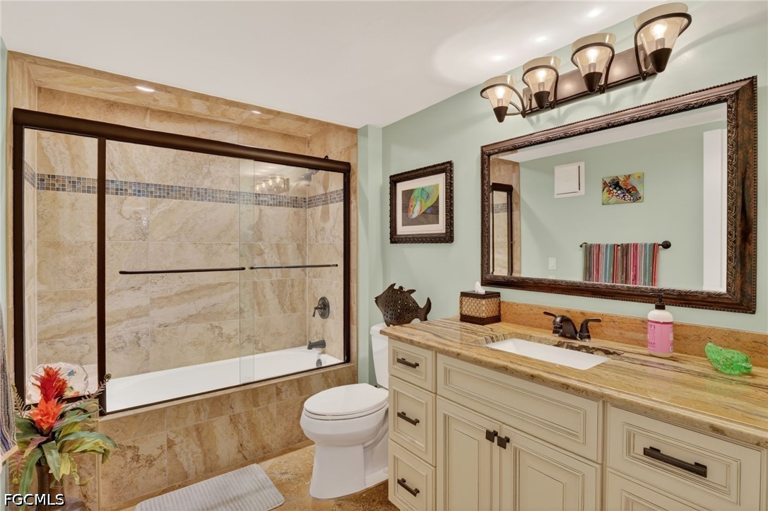 1900 Virginia Avenue, Unit 802 Fort Myers, FL 33901 - Photo 24 of 33 a bathroom with a granite countertop sink mirror vanity and toilet