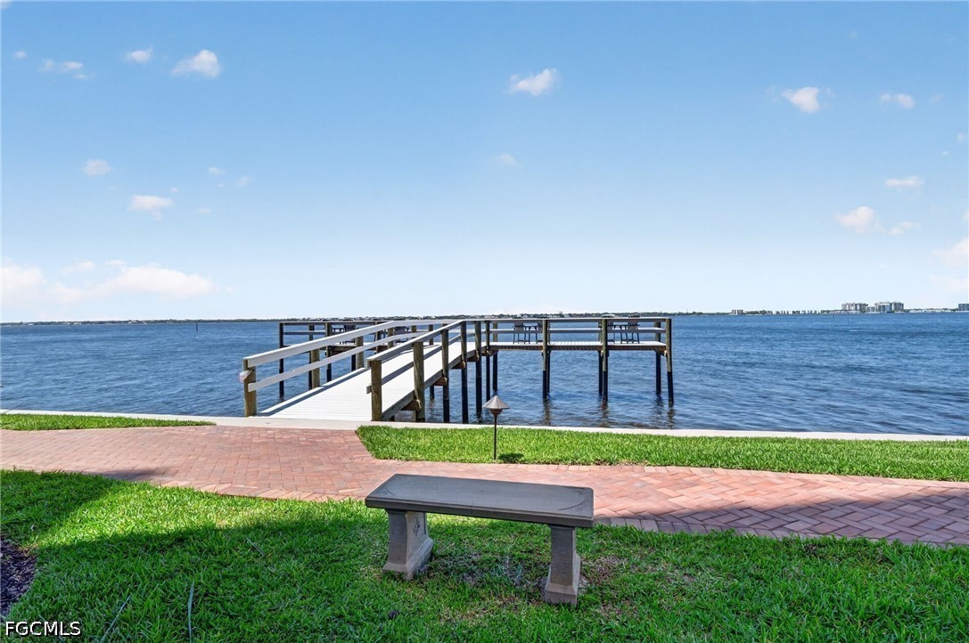 1900 Virginia Avenue, Unit 802 Fort Myers, FL 33901 - Photo 27 of 33 a view of a chairs and bench in the yard