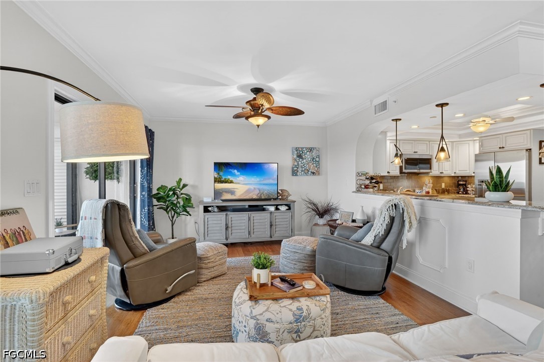 1900 Virginia Avenue, Unit 802 Fort Myers, FL 33901 - Photo 7 of 33 a living room with furniture flat screen tv and a large window
