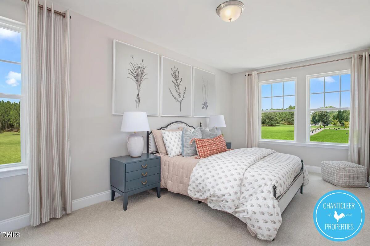 24 Hyacinth Lane, Unit 99 Angier, NC 27501 - Photo 8 of 9 a bedroom with a bed and a window