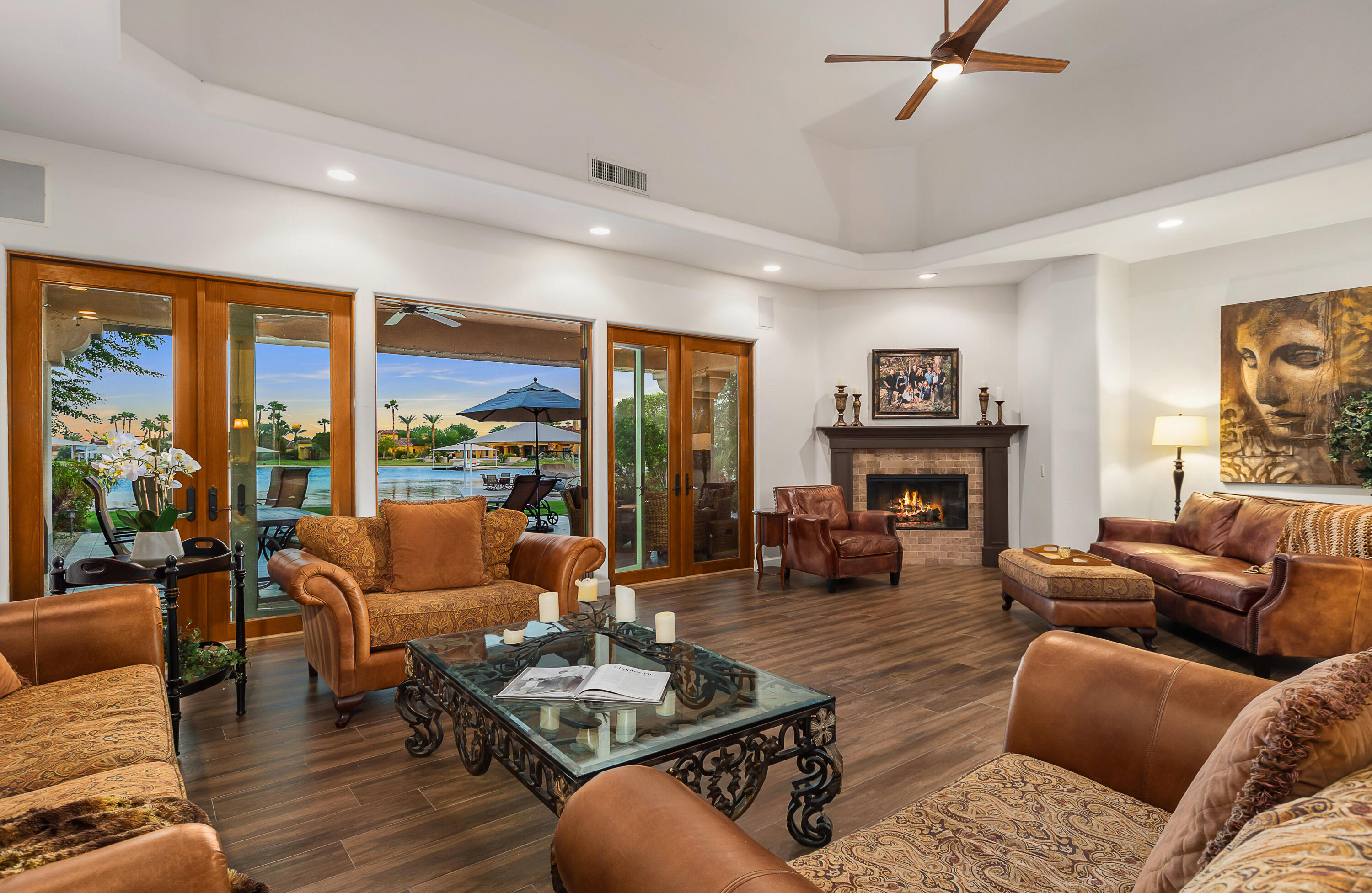 a living room with furniture fireplace and a large window