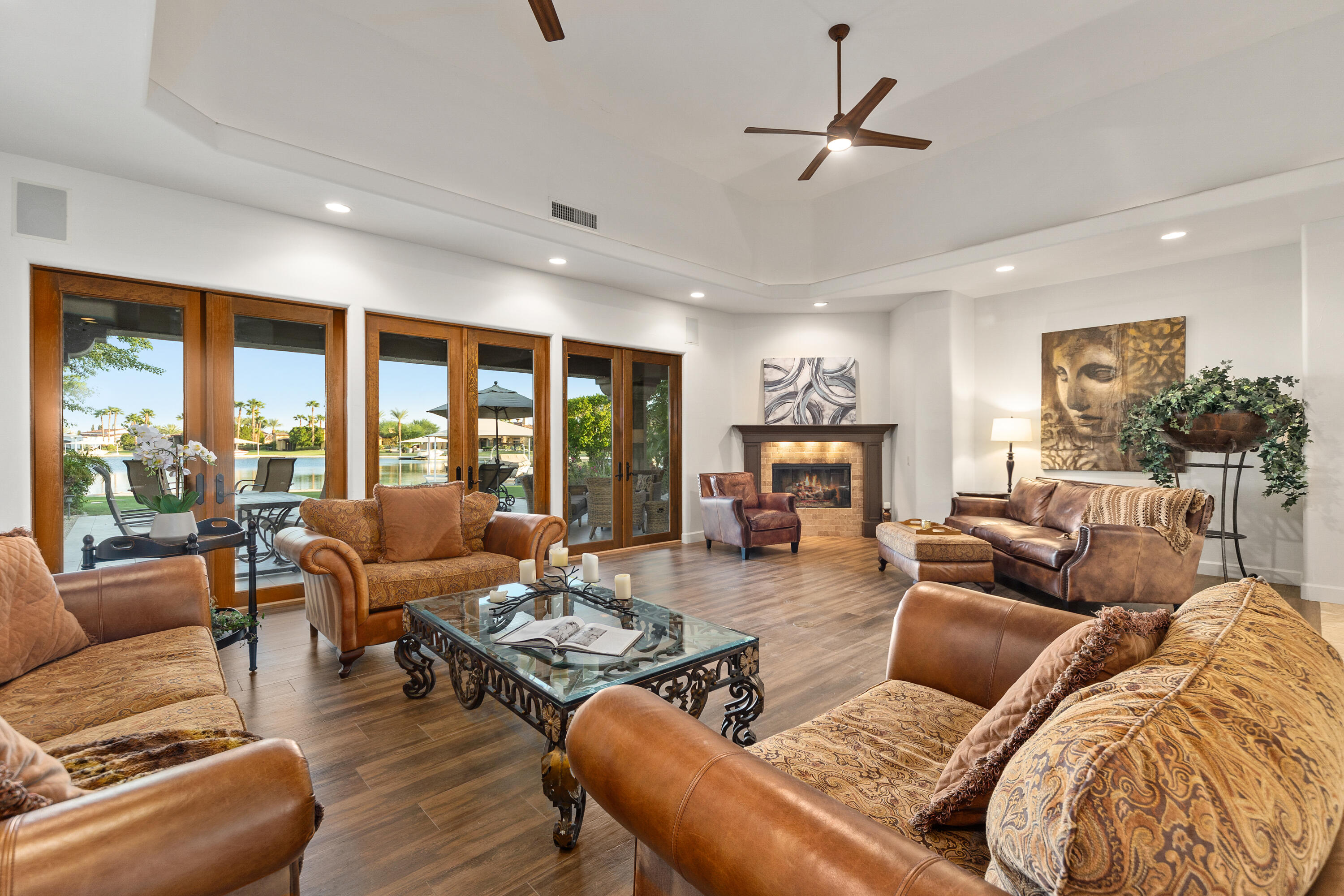83005 North Shore Drive Indio, CA 92203 - Photo 16 of 40 a living room with furniture large windows and a fireplace