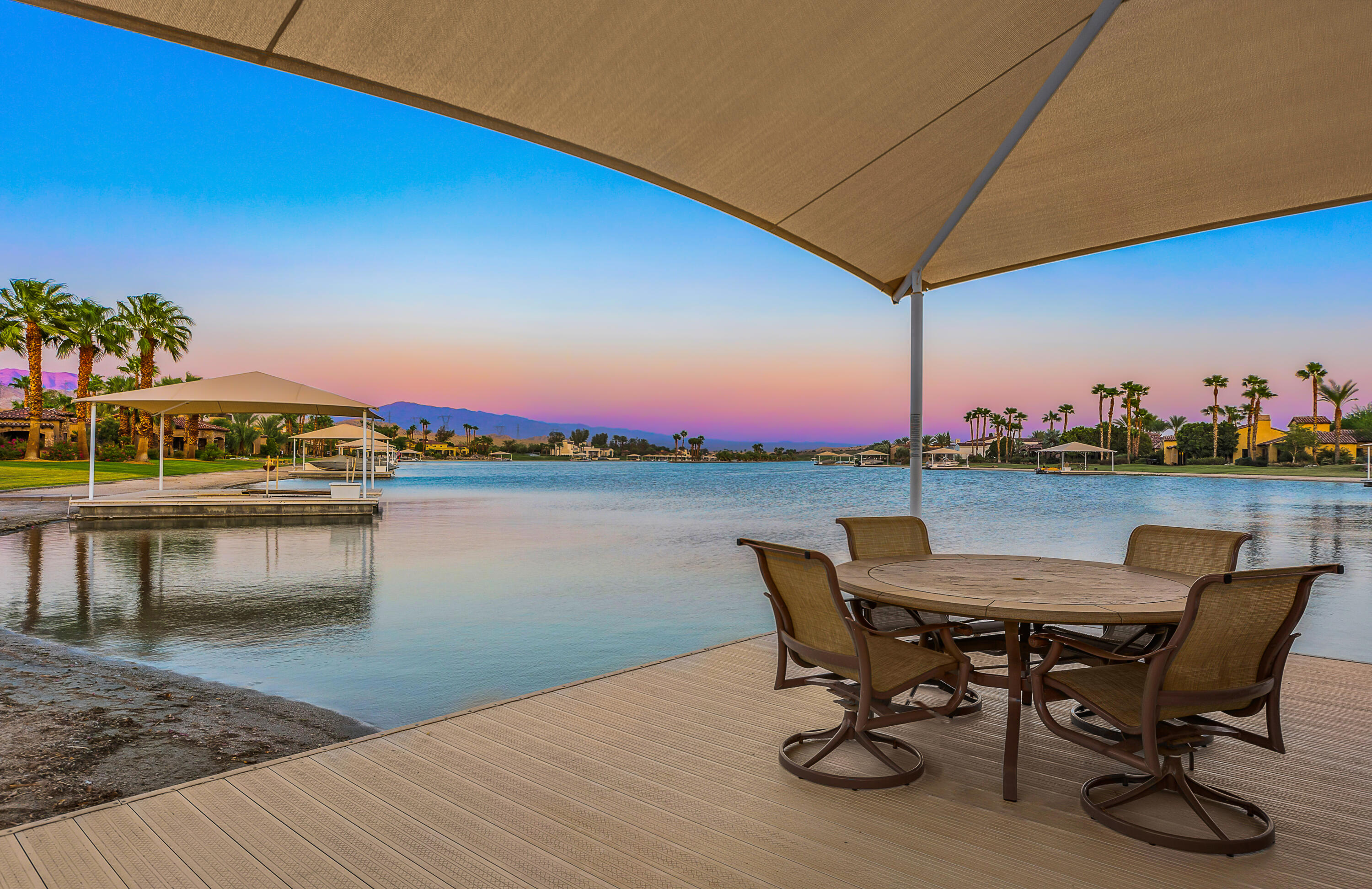83005 North Shore Drive Indio, CA 92203 - Photo 2 of 40 a view of a lake with a table and chairs