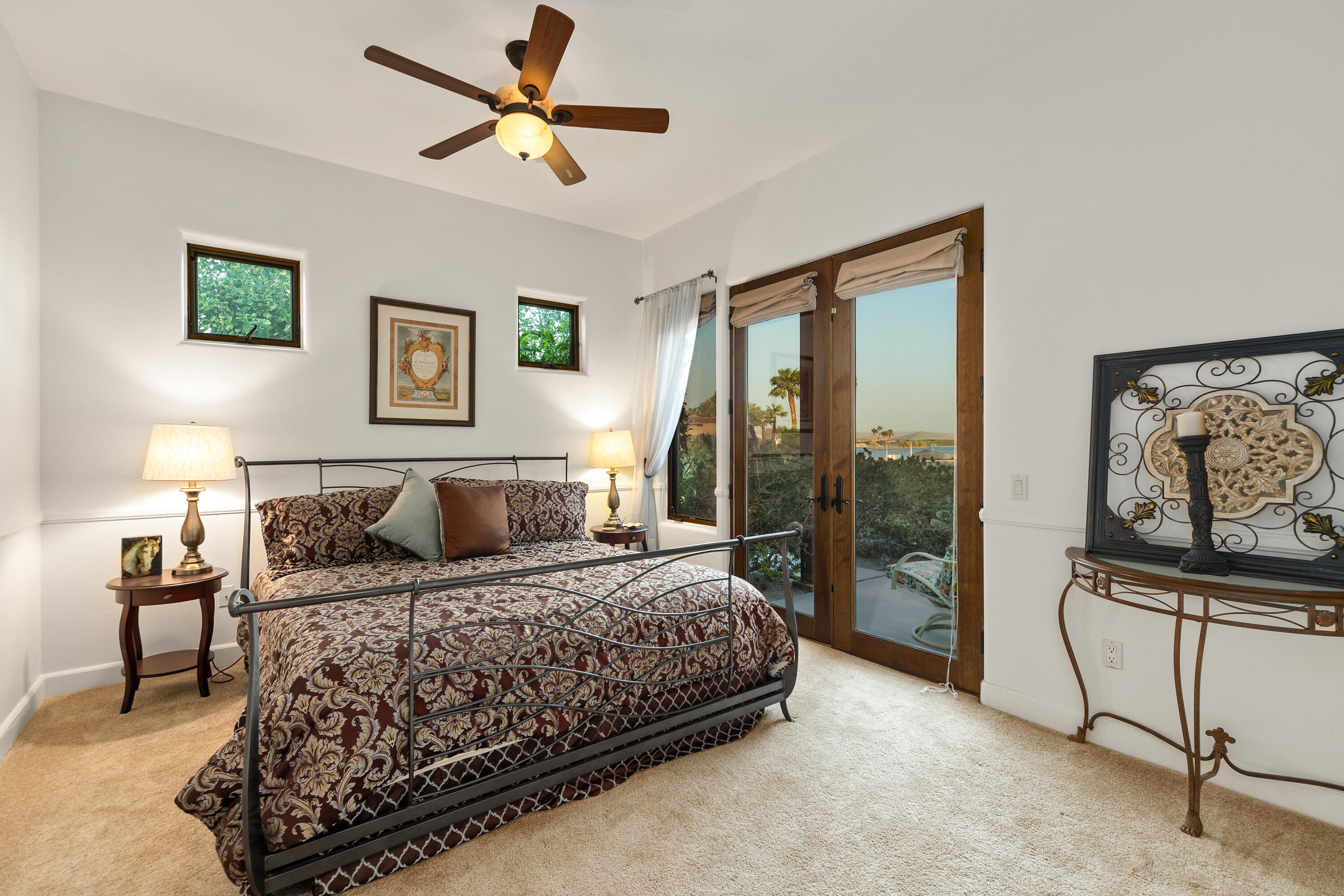 83005 North Shore Drive Indio, CA 92203 - Photo 30 of 40 a bedroom with a large bed and a chandelier