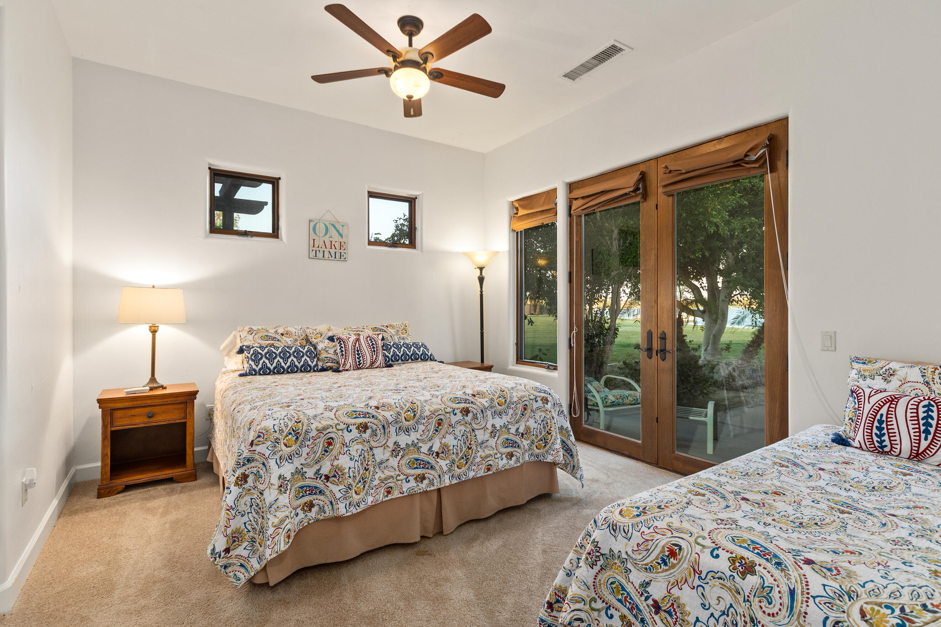 83005 North Shore Drive Indio, CA 92203 - Photo 31 of 40 a bedroom with a large bed and a chandelier