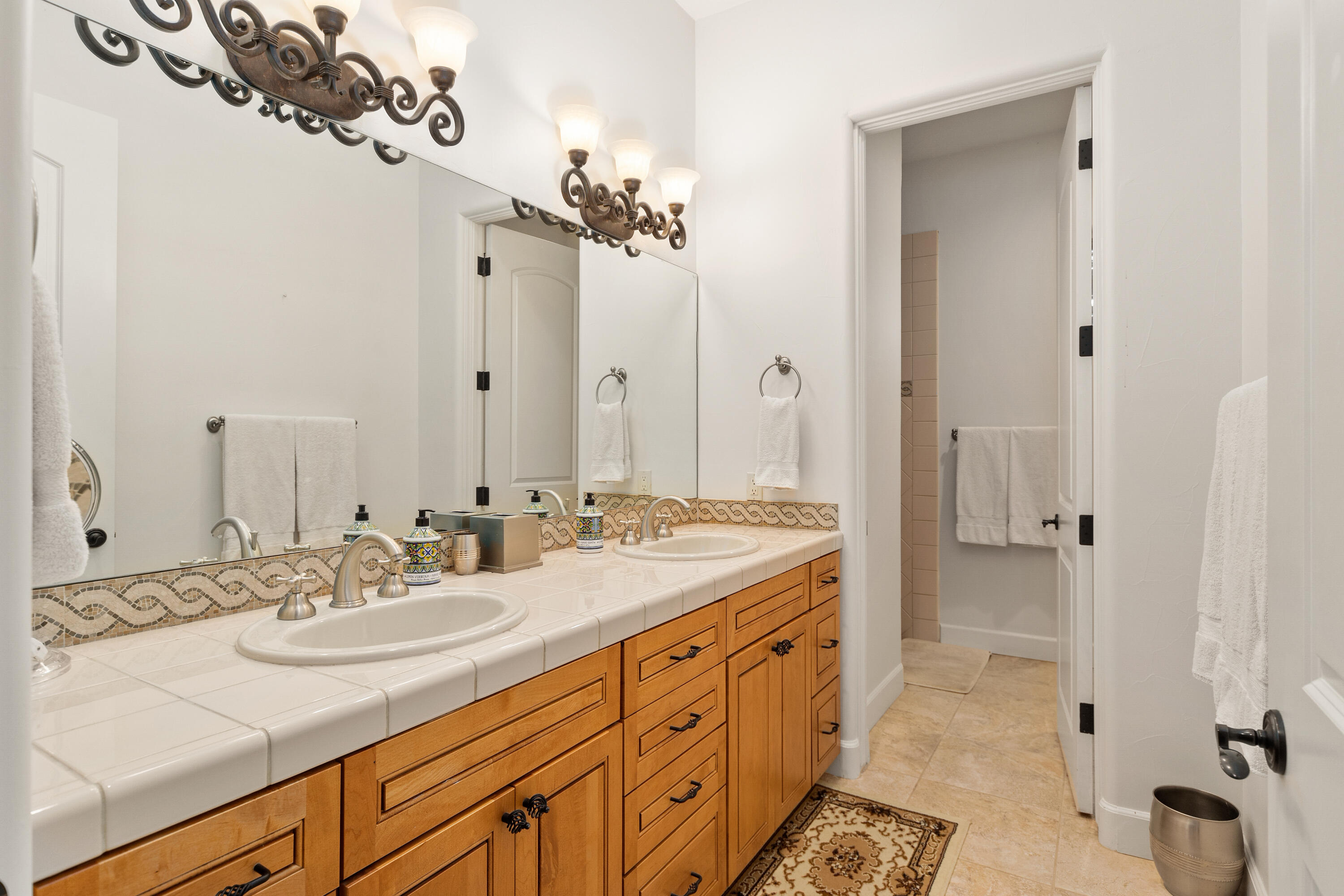 83005 North Shore Drive Indio, CA 92203 - Photo 34 of 40 a bathroom with a sink a mirror and a bathtub