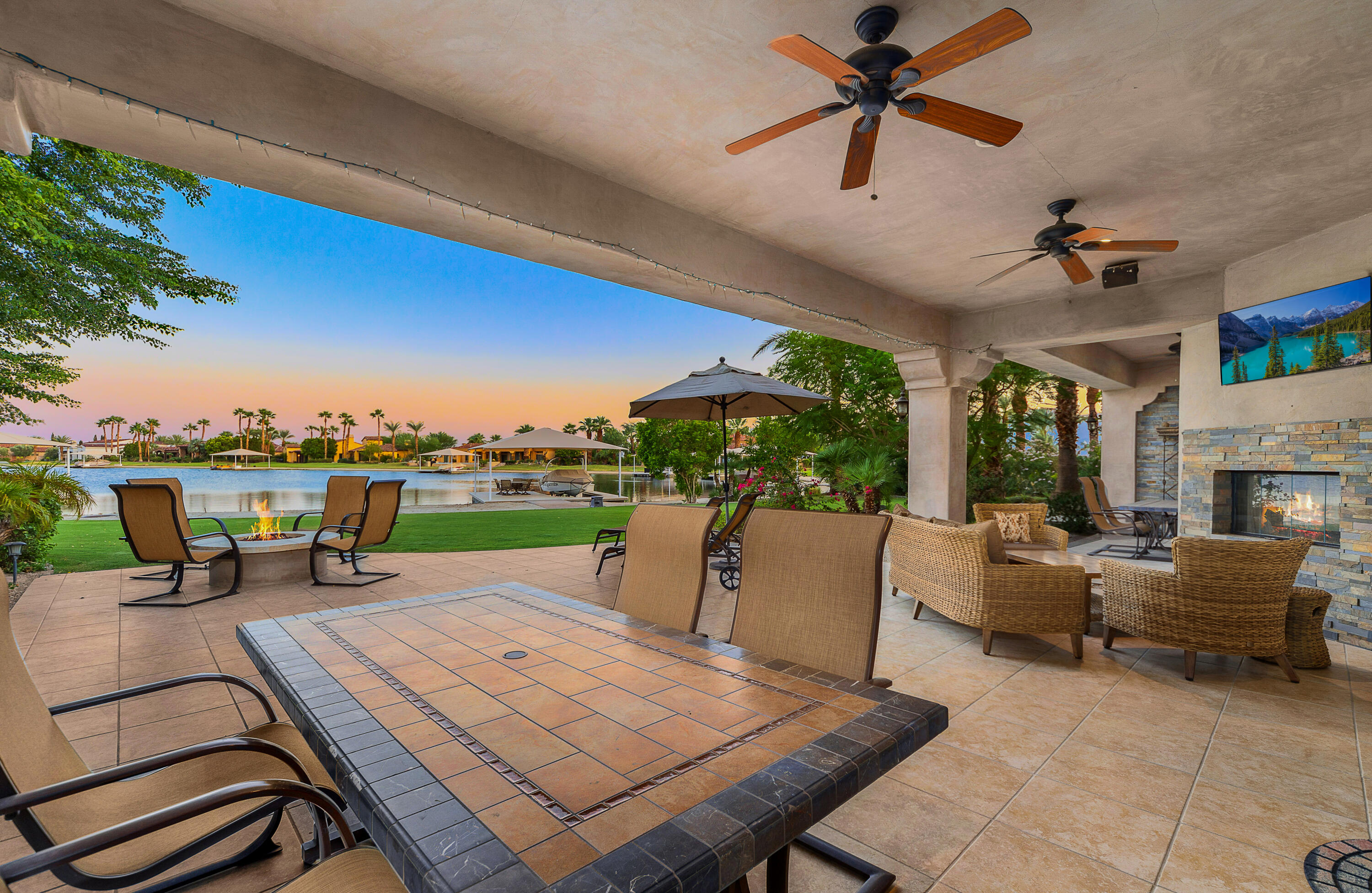 83005 North Shore Drive Indio, CA 92203 - Photo 4 of 40 a roof deck with table and chairs couches with wooden floor and fence