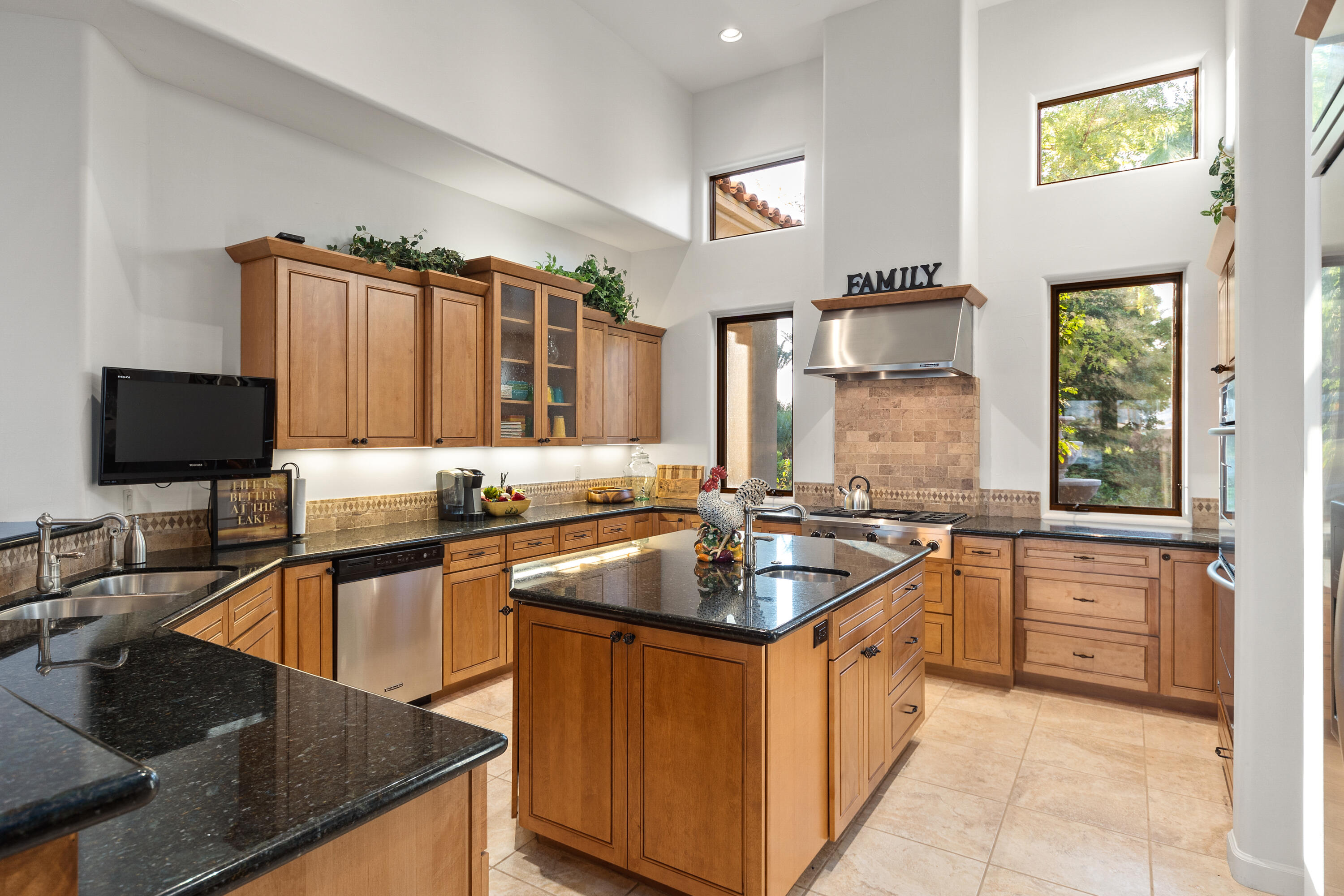 83005 North Shore Drive Indio, CA 92203 - Photo 6 of 40 a kitchen with stainless steel appliances granite countertop a sink a stove and a microwave