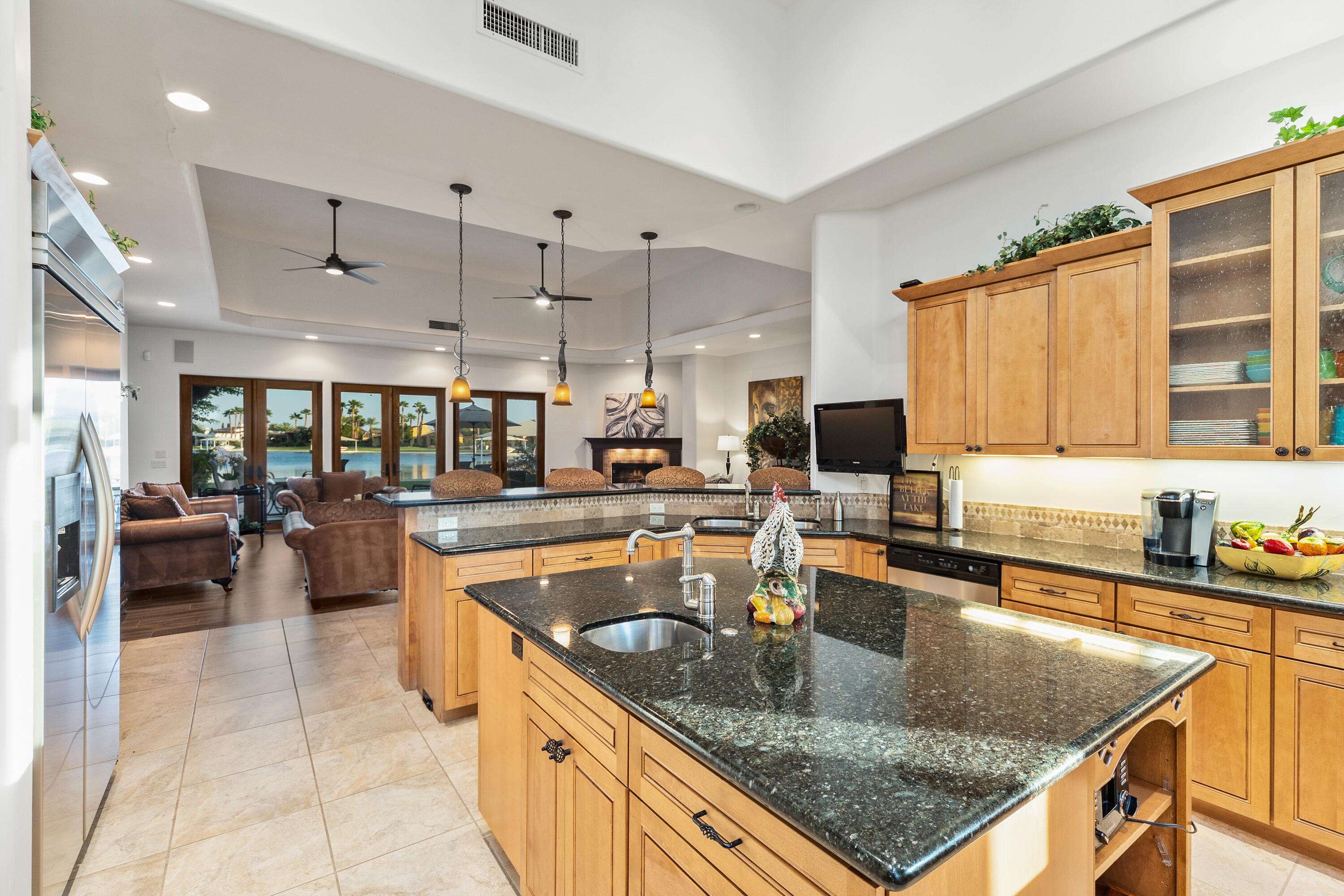 83005 North Shore Drive Indio, CA 92203 - Photo 8 of 40 a kitchen with stainless steel appliances granite countertop a sink a stove and a wooden cabinets