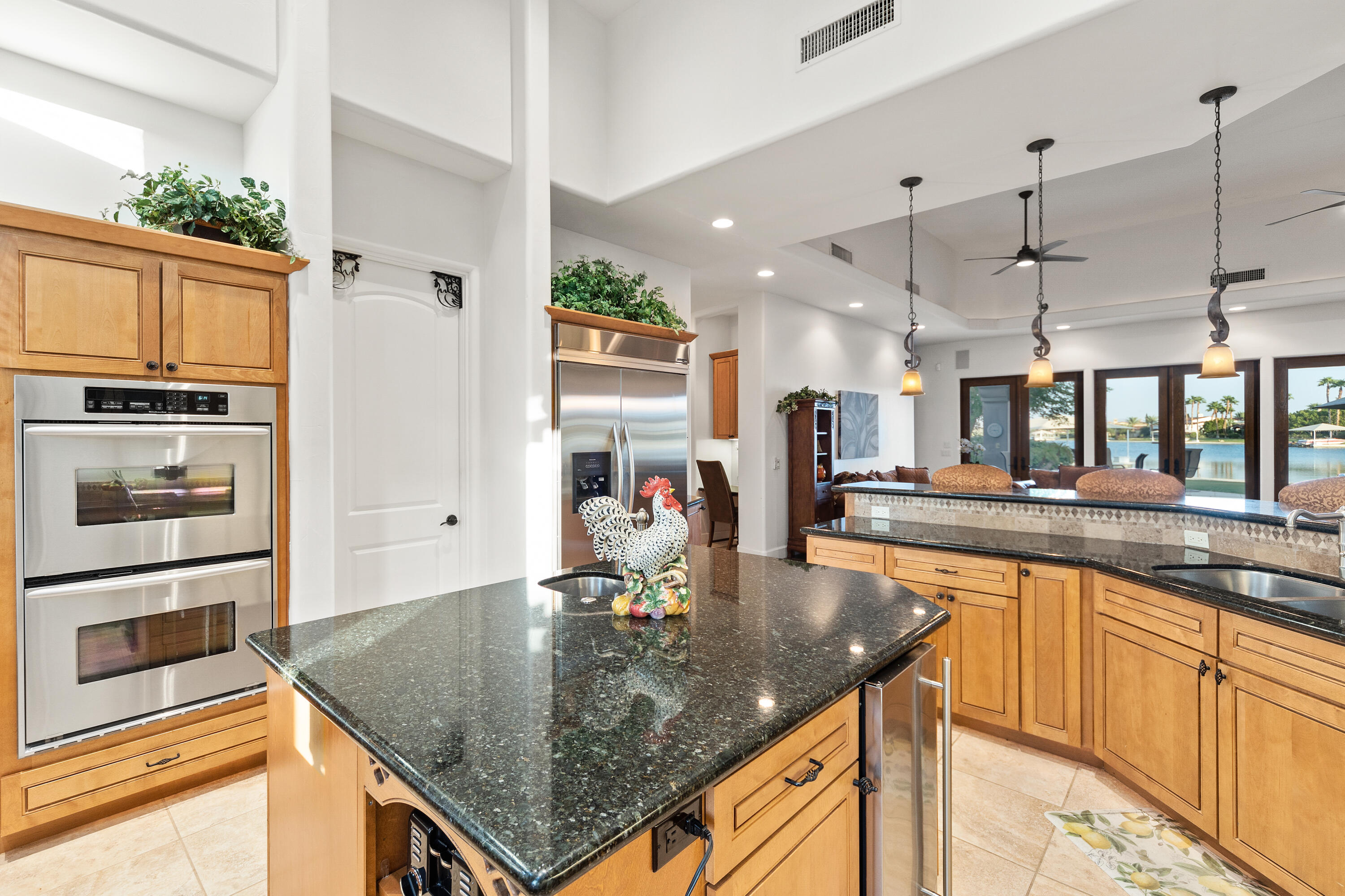 83005 North Shore Drive Indio, CA 92203 - Photo 10 of 40 a kitchen with stainless steel appliances granite countertop a sink counter space and cabinets