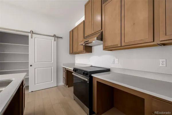 a kitchen with stainless steel appliances granite countertop a stove and a refrigerator