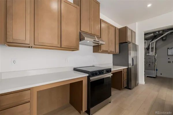 a kitchen with a sink and a refrigerator