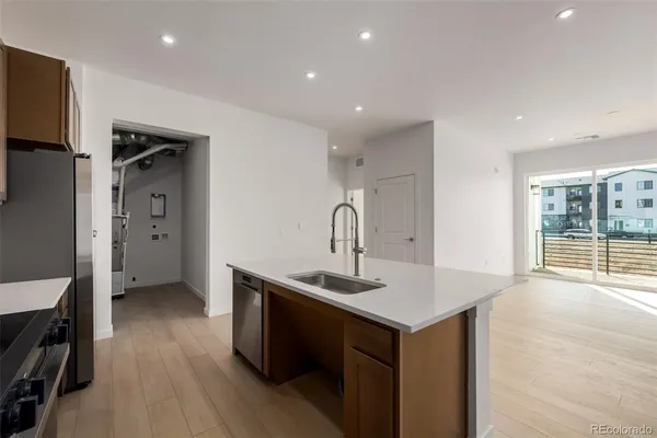 a kitchen with a sink and large window