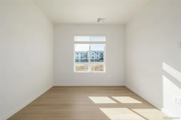 a bathroom with a granite countertop sink toilet a mirror and shower