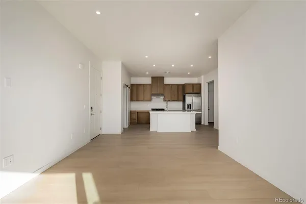 a view of a kitchen with a sink and a refrigerator