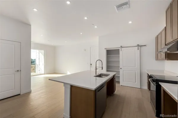 a kitchen with stainless steel appliances a stove and a refrigerator
