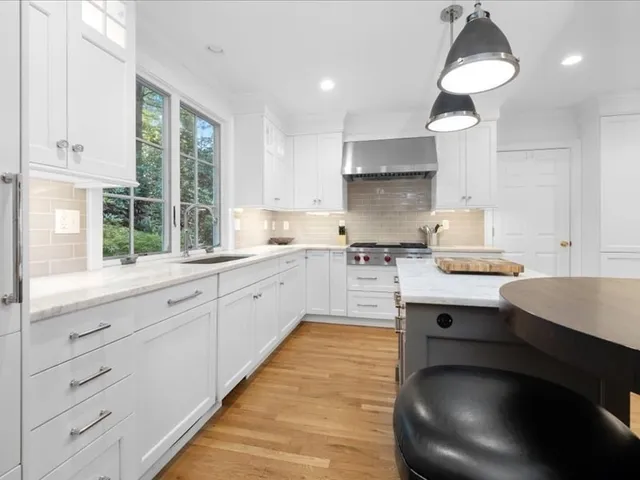 a kitchen with cabinets appliances and a window
