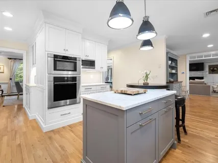 a kitchen with stainless steel appliances a stove refrigerator and microwave