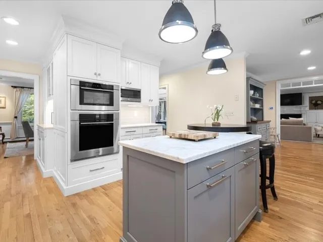 a kitchen with stainless steel appliances a stove refrigerator and microwave