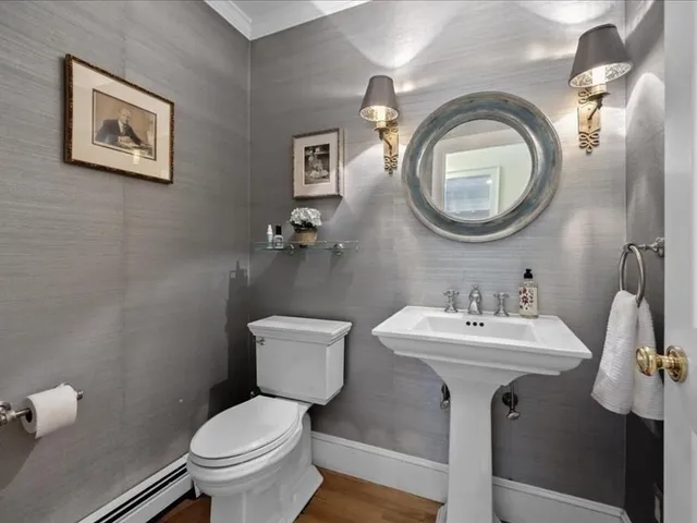 a bathroom with a toilet a sink and a mirror