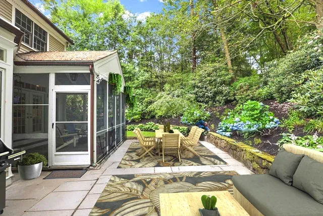a view of a patio with couches table and chairs and potted plants