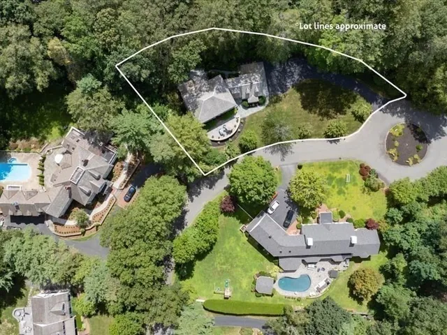 an aerial view of a house with yard swimming pool and outdoor seating