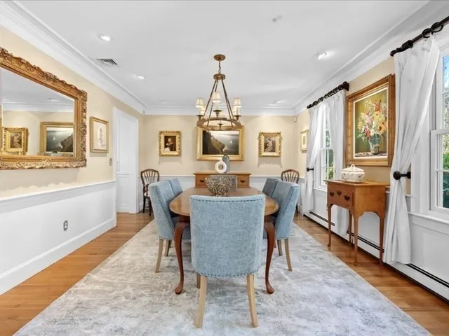 a dining room with furniture a chandelier and wooden floor