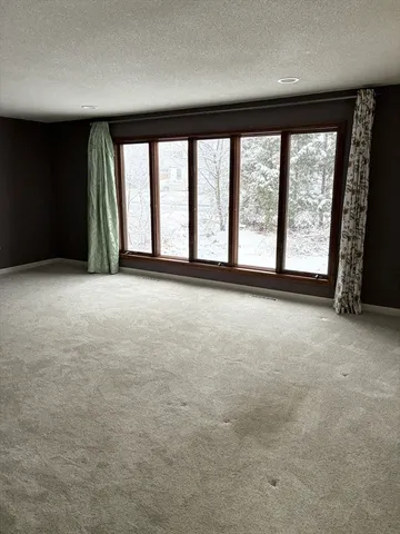 an empty room with windows and city view