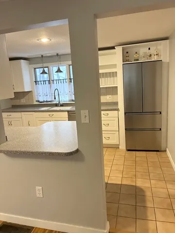 a kitchen with stainless steel appliances a refrigerator and cabinets