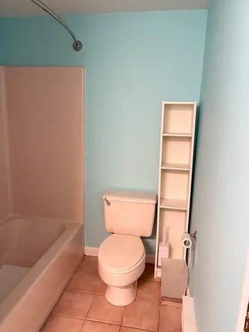 a bathroom with a toilet and a bathtub